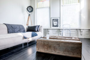 Gebürsteter Pollertisch mit Wasserglas in modernem Interieur