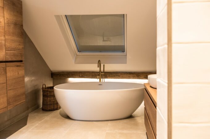 Old oak beams in modern bathroom with bathtub