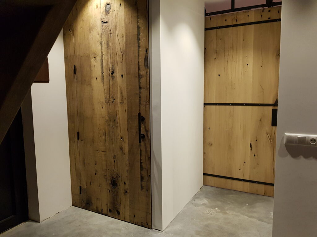 Doors of planed oak wagon planks in white wall