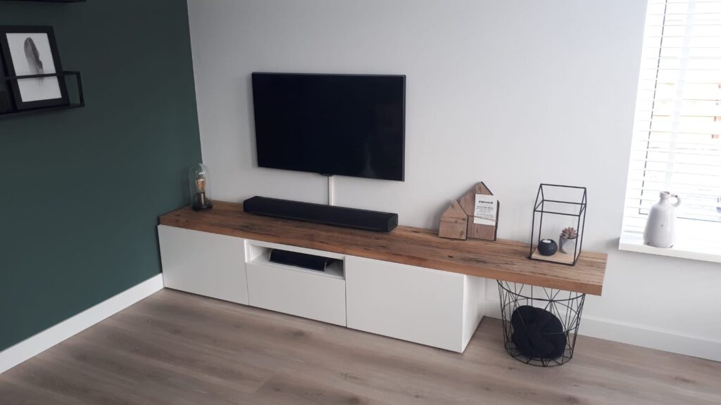 Ikea tv furniture on which an oak wagon shelves are attached