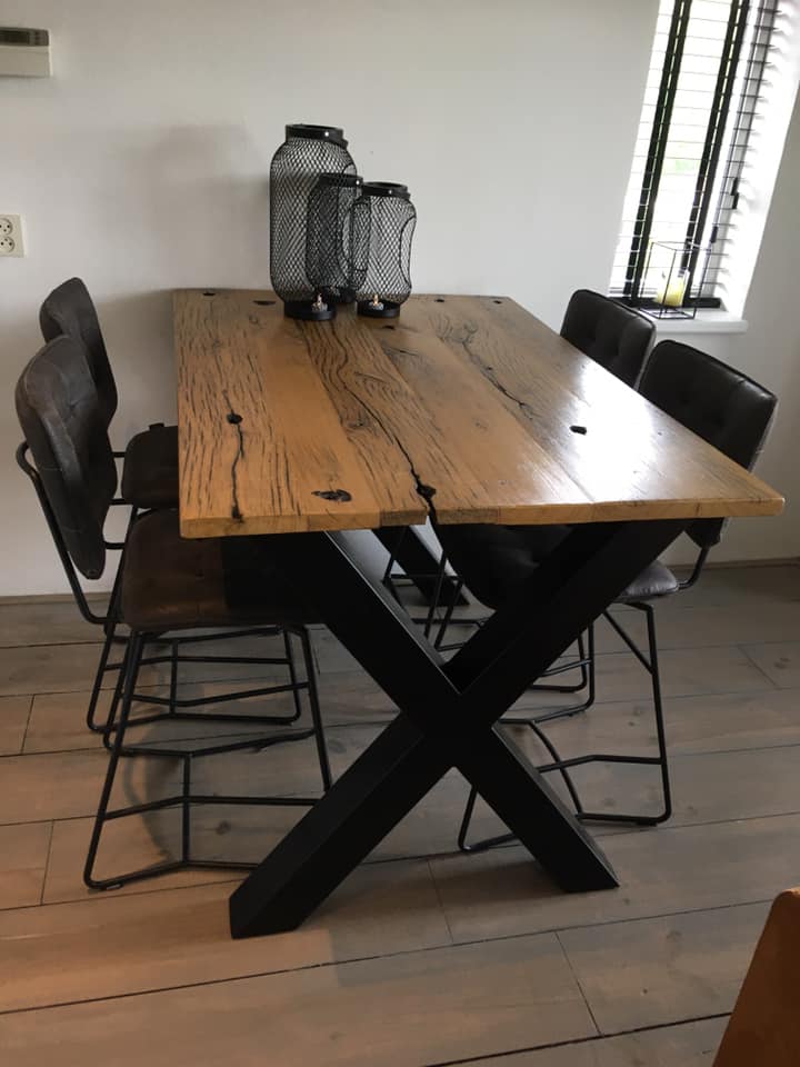 Dining room table of planed wagon planks with black x-foot