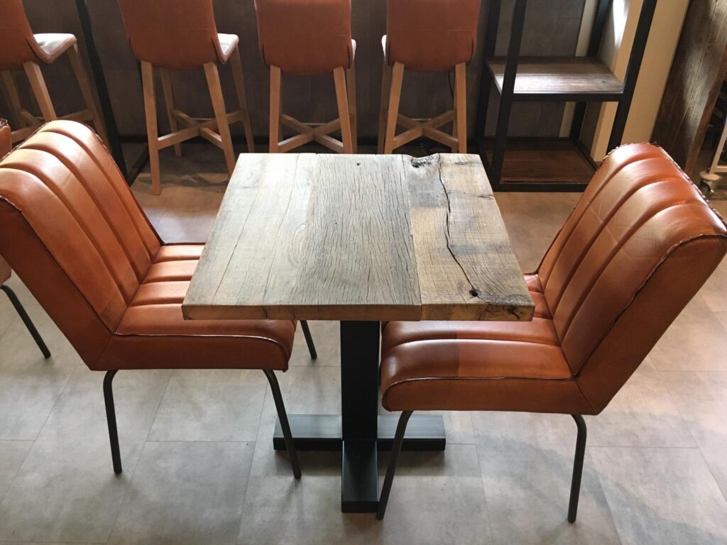 Dining table made from old oak wagon planks in restaurant jumbo