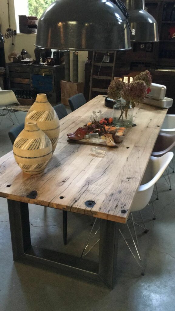 Presentation of a table made of wagon planks with a drawing in a home furnishing store