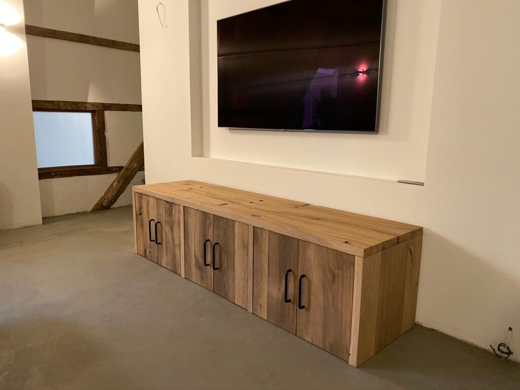 cabinet under television of old oak planed wagon planks for white wall