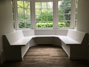 Presentation floor of old oak outside, rough appearance laid with straight sections for white wooden bench