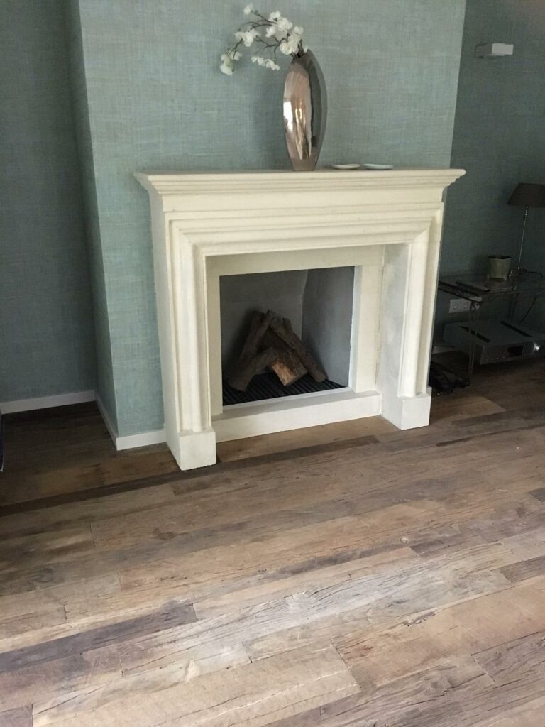 Presentation floor of old oak outside laid with straight parts for white fireplace