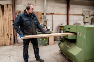 Naschaven van de samengestelde wagonplanken in de oud hout loods