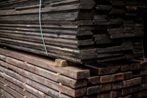 Präsentation eines Pakets unbearbeiteter Waggonbretter in einem alten Holzschuppen