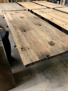 Multiple tables brushed wagon planks side by side with color differences