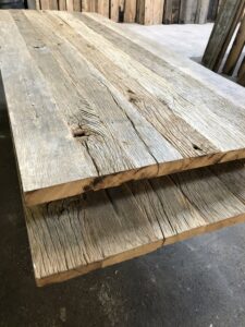 Presentation of barnwood oak table tops in the old wood shed